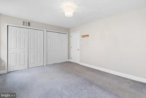 an empty room with closet area
