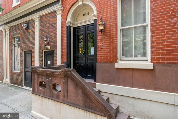 a view of a brick house with a large window