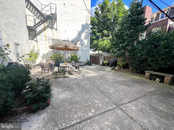 a view of a backyard with sitting area