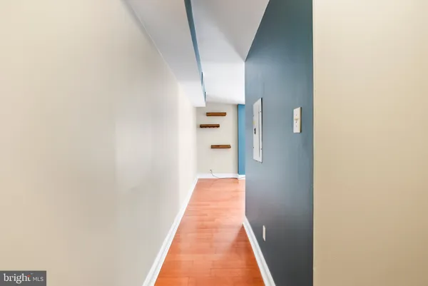 a view of a hallway with wooden floor