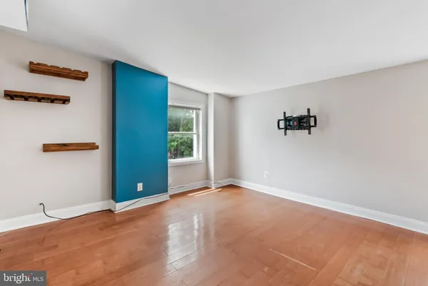 an empty room with windows and closet