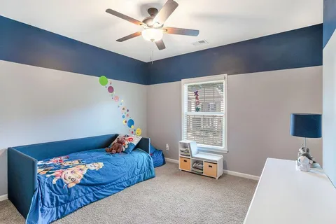 a bedroom with furniture and a window