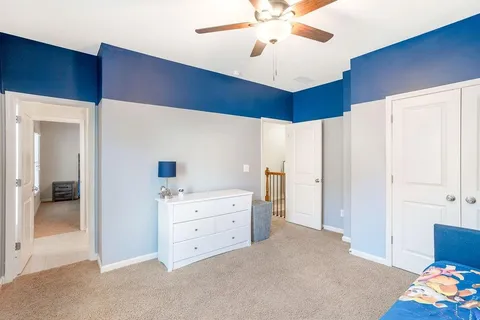 a view of a livingroom with a cabinet and a chandelier fan