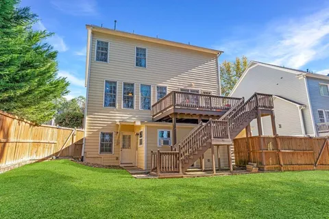 a view of a house with a yard and sitting area