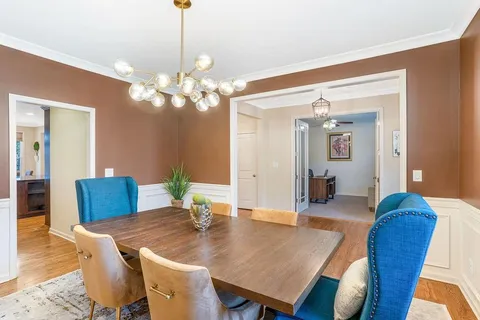 a view of a dining room with furniture and wooden floor