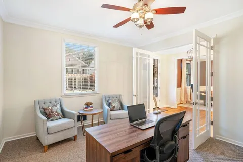 a living room with furniture a table and a window
