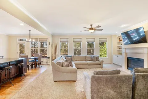 a living room with furniture fireplace and flat screen tv