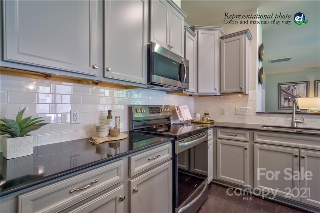 116 Tackle, Unit DRIVE 266 Troutman, NC 28166 - Photo 5 of 15 a kitchen with stainless steel appliances granite countertop a sink a stove and cabinets