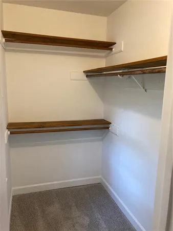 a bathroom with a granite countertop sink a mirror and next to a window