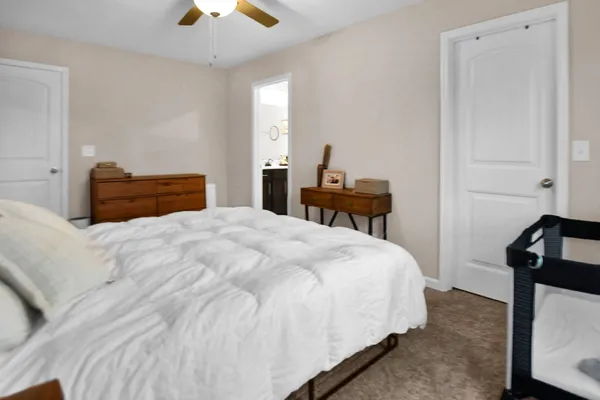 a bedroom with a bed and a chandelier