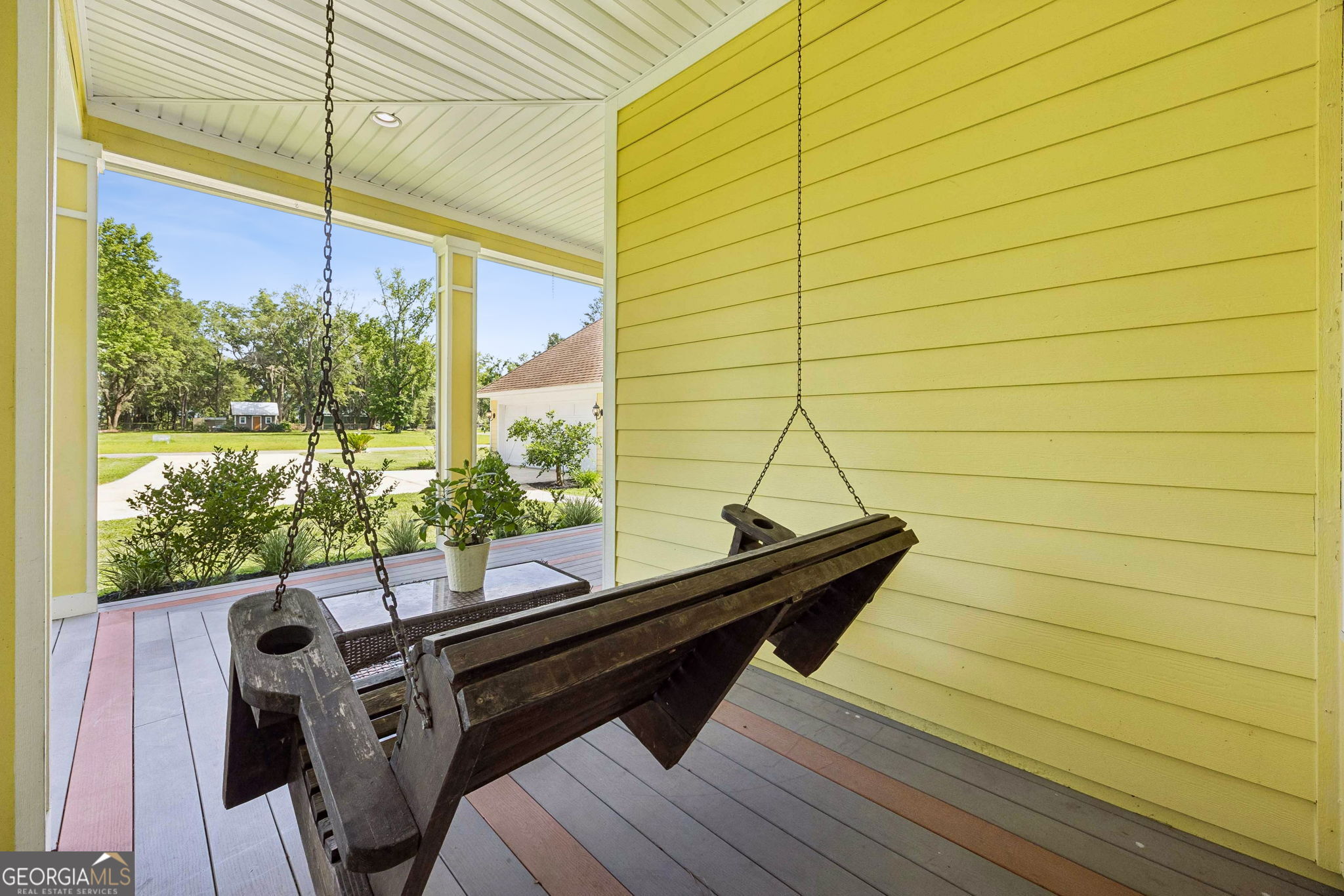 706 Hopewell Point Road White Oak, GA 31568 - Photo 64 of 84 A covered porch swing creates a quiet retreat for enjoying fresh air, peaceful views, and the relaxed pace of coastal Georgia living.