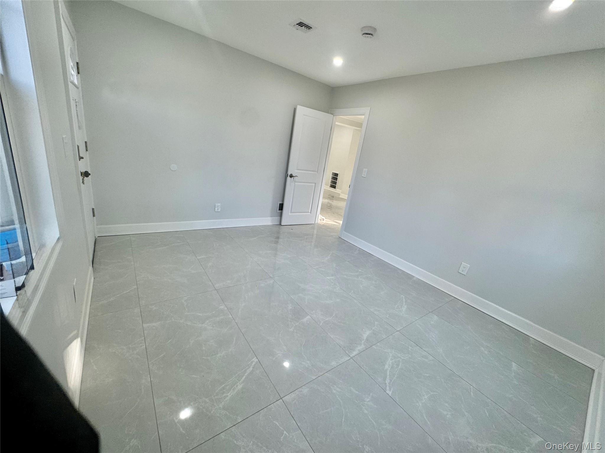 32 A Berkshire Road Great Neck, NY 11023 - Photo 15 of 38 First floor bedroom or office with separate entrance light marble finish floors and recessed lighting