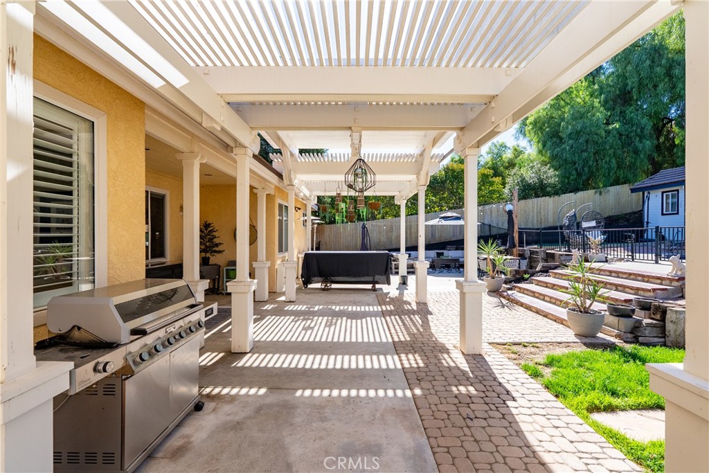 1329 Crown Way Paso Robles, CA 93446 - Photo 36 of 57 a view of a patio with table and chairs potted plants with wooden floor