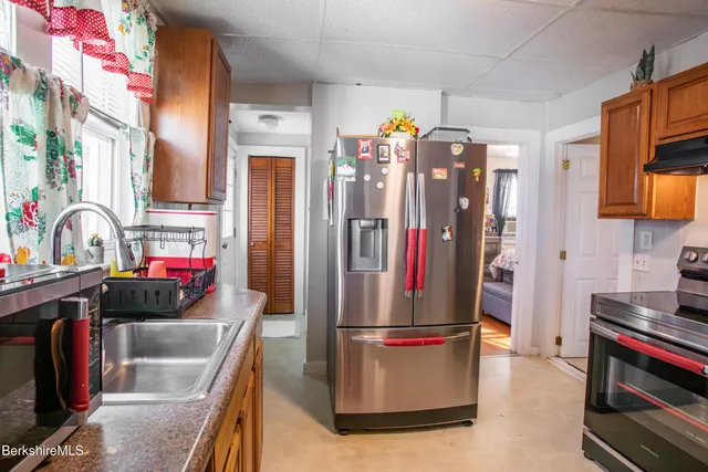 a kitchen with stainless steel appliances granite countertop a refrigerator and a stove