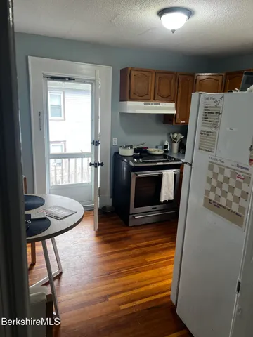 a kitchen with a refrigerator and a stove