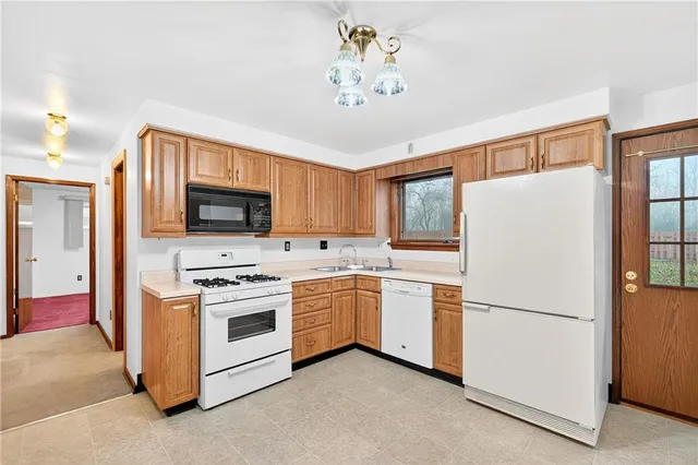 a kitchen with stainless steel appliances white cabinets and a sink