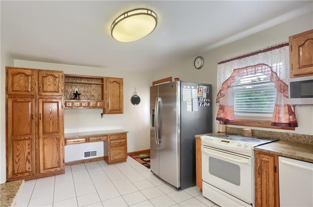 104 Hepler Road Sarver, PA 16055 - Photo 13 of 30 a kitchen that has a refrigerator and a stove