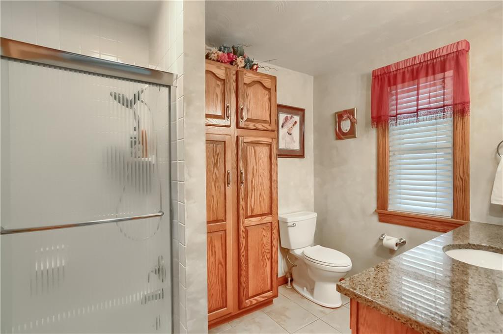 104 Hepler Road Sarver, PA 16055 - Photo 20 of 30 a bathroom with a granite countertop shower toilet and sink