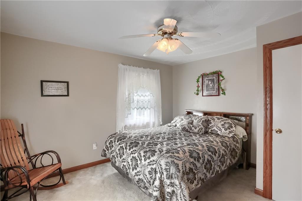 104 Hepler Road Sarver, PA 16055 - Photo 21 of 30 a bedroom with a bed and a chandelier