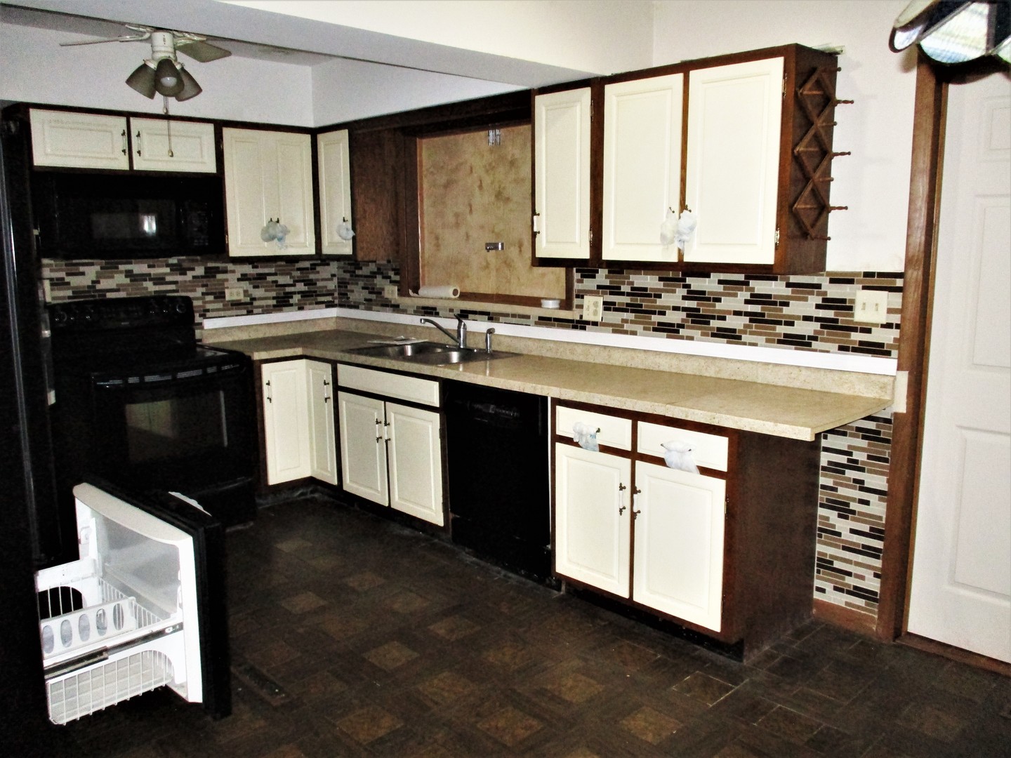 16814 Green Road Harvard, IL 60033 - Photo 3 of 18 a kitchen with stainless steel appliances granite countertop a stove a sink and a microwave