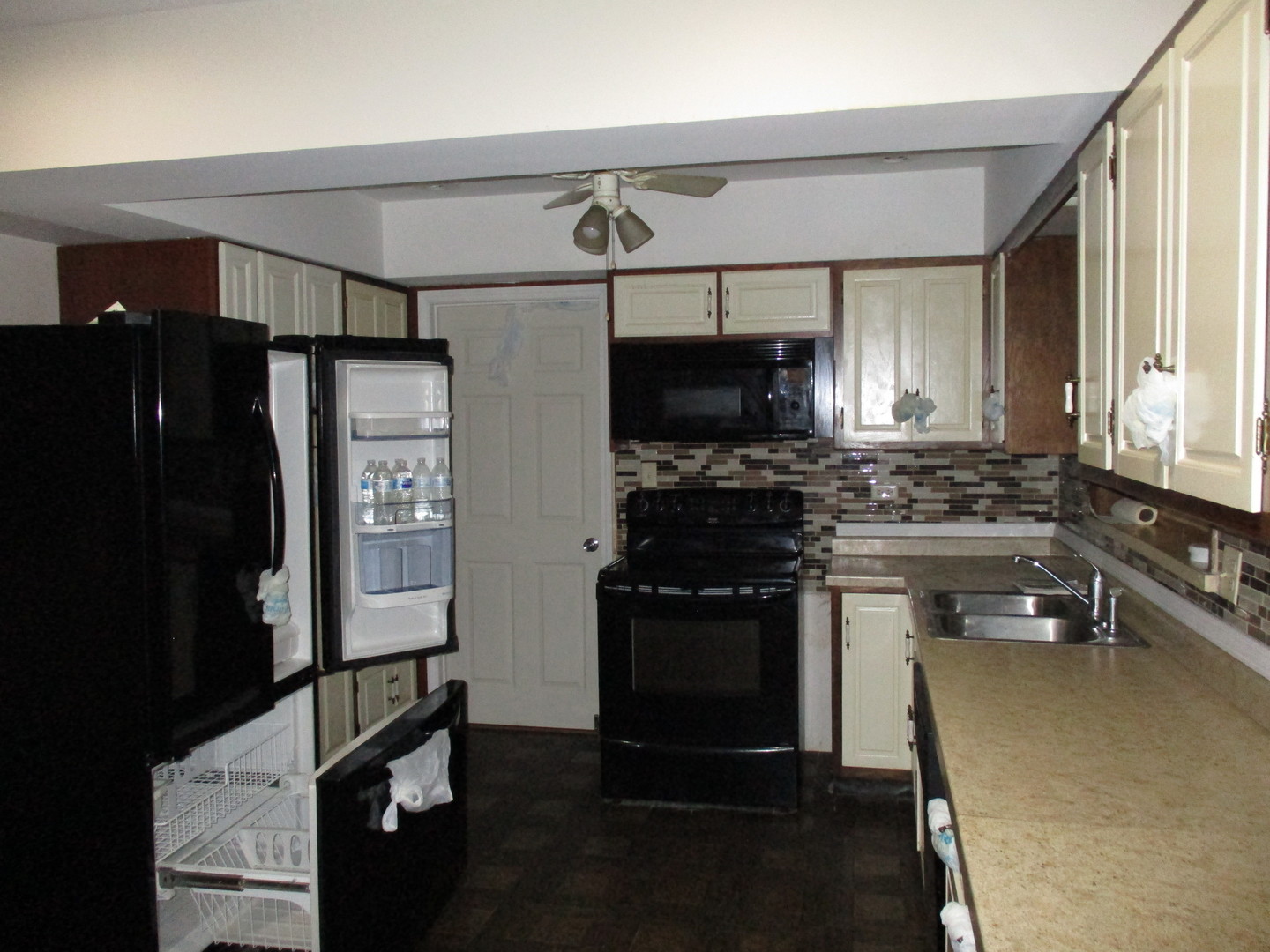 16814 Green Road Harvard, IL 60033 - Photo 5 of 18 a kitchen with stainless steel appliances a refrigerator stove and microwave