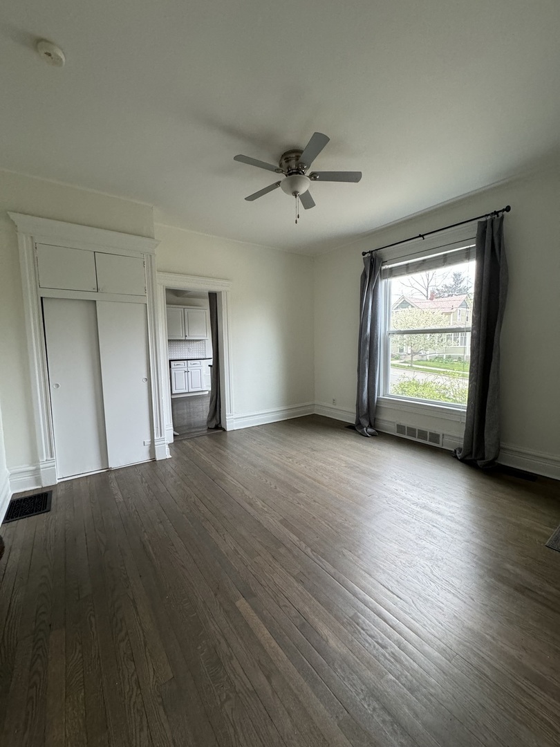 103 South 4th Street, Unit 1 St. Charles, IL 60174 - Photo 14 of 22 a view of an empty room with a window and wooden floor