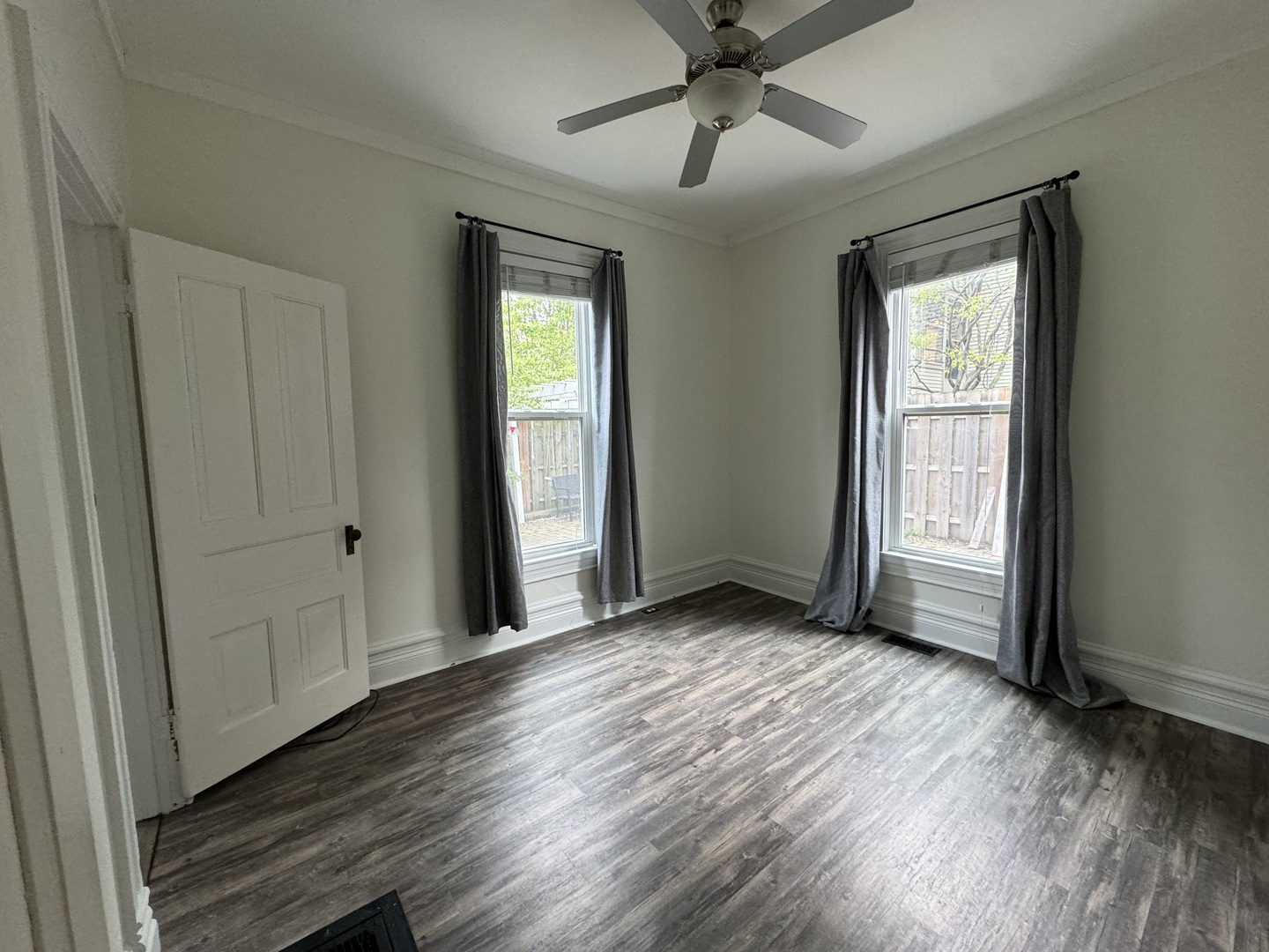 103 South 4th Street, Unit 1 St. Charles, IL 60174 - Photo 16 of 22 a view of a livingroom with wooden floor and a ceiling fan