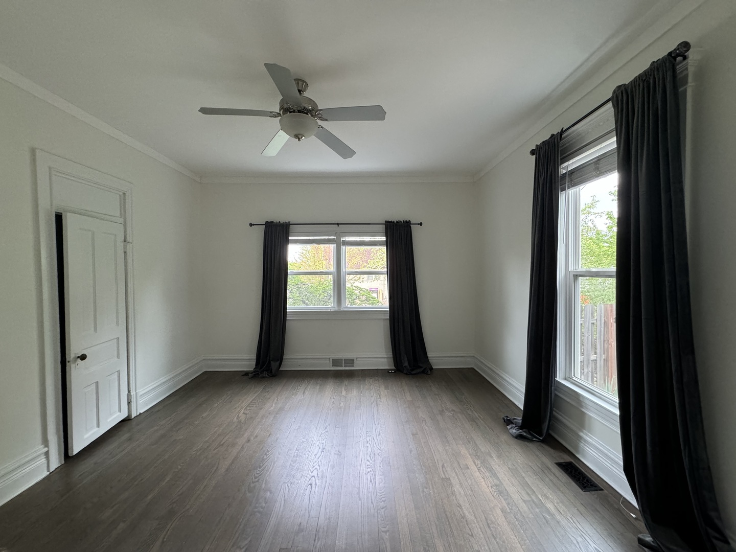 103 South 4th Street, Unit 1 St. Charles, IL 60174 - Photo 17 of 22 an empty room with wooden floor a ceiling fan and windows