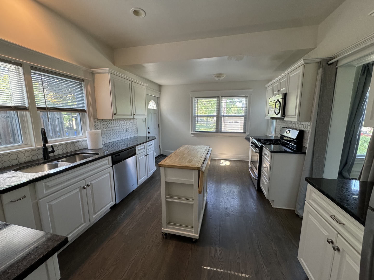 103 South 4th Street, Unit 1 St. Charles, IL 60174 - Photo 5 of 22 a kitchen with stainless steel appliances wooden floors and large window