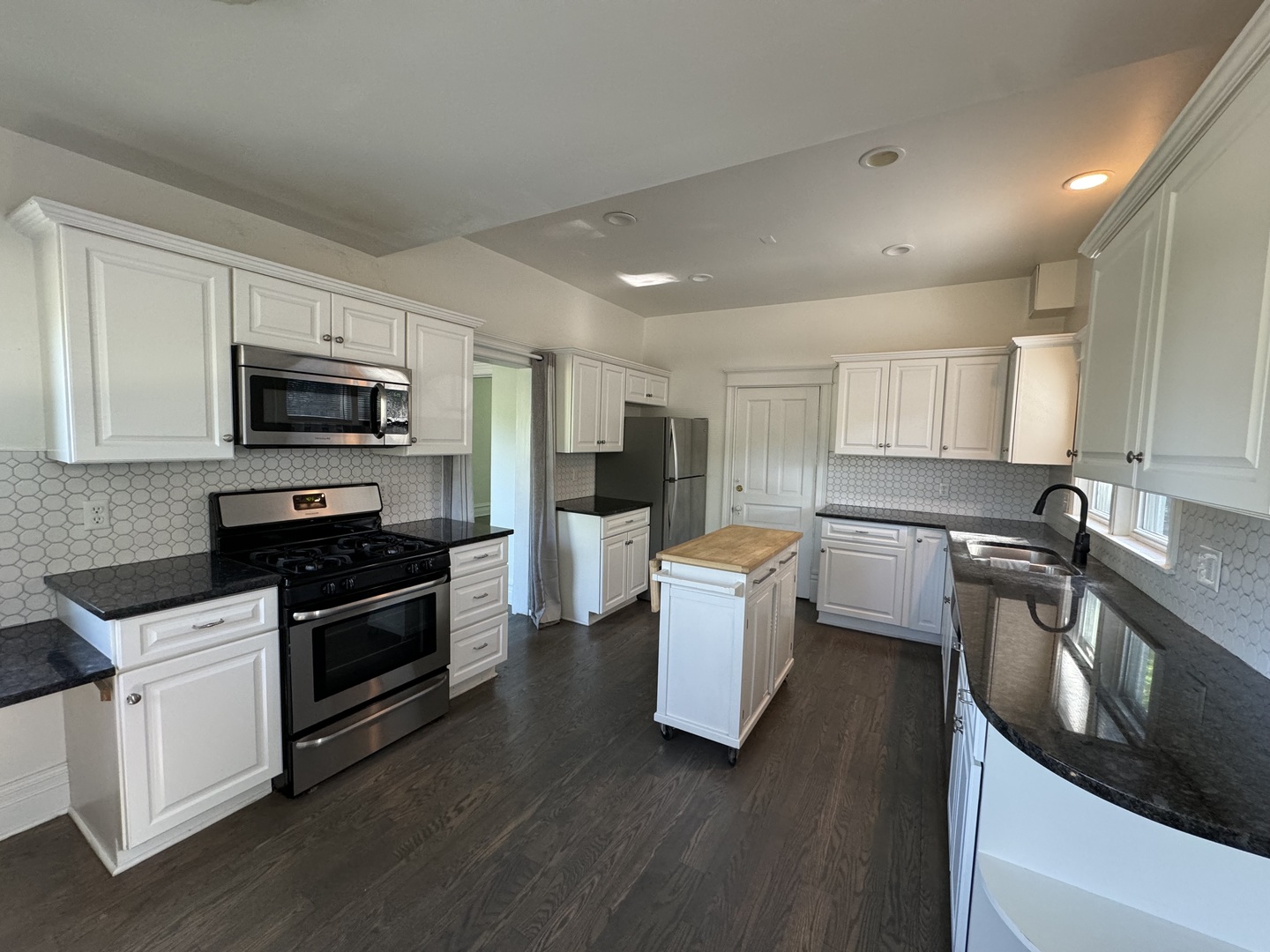 103 South 4th Street, Unit 1 St. Charles, IL 60174 - Photo 6 of 22 a kitchen with a sink cabinets and stainless steel appliances