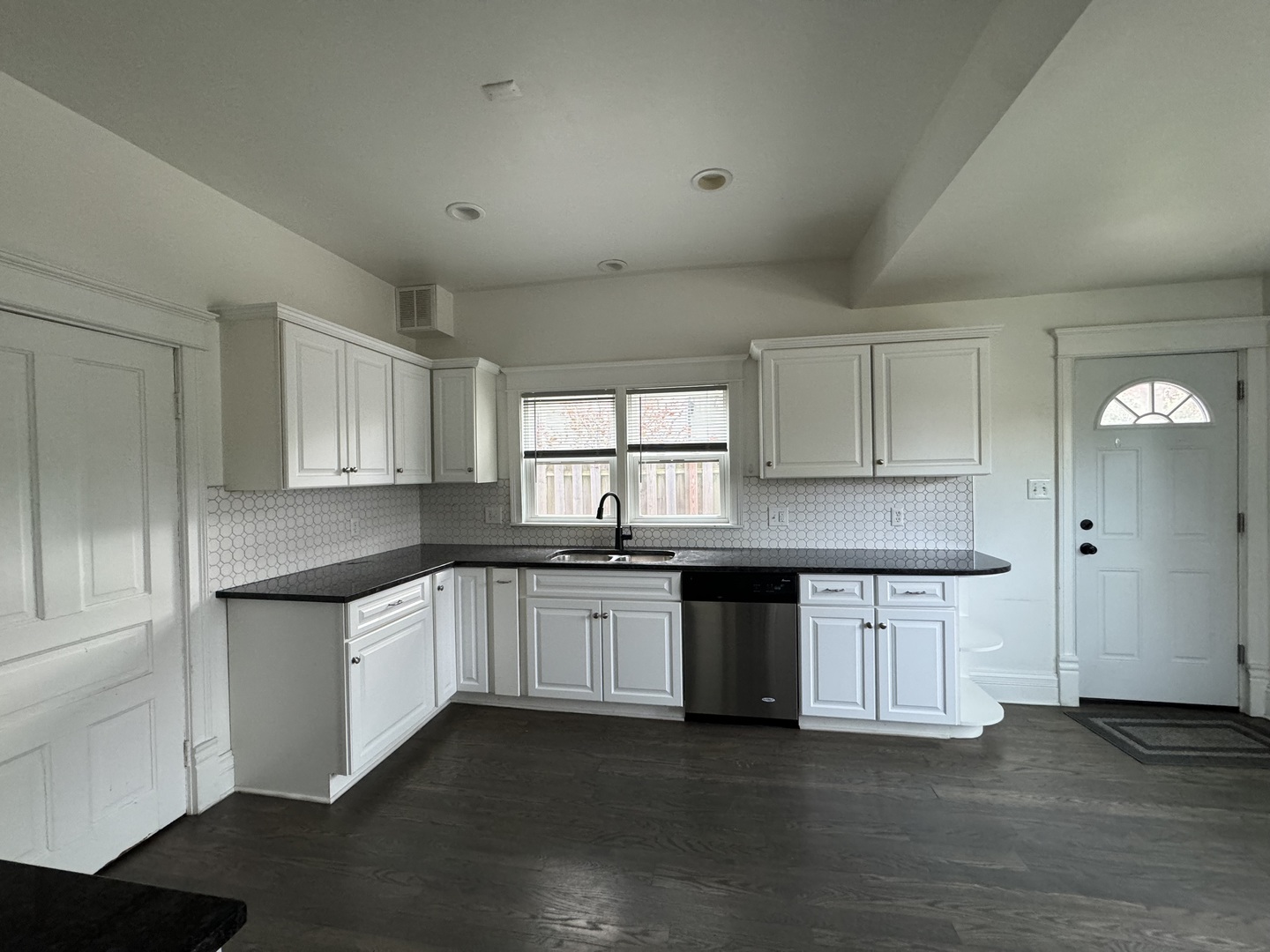 103 South 4th Street, Unit 1 St. Charles, IL 60174 - Photo 8 of 22 a kitchen with granite countertop a sink and dishwasher a stove top oven with wooden floor