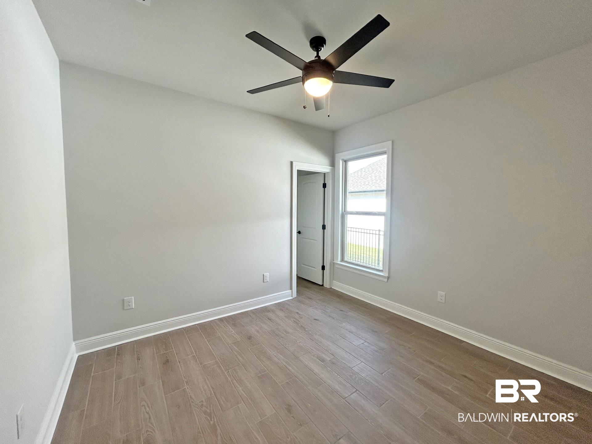 825 Sumter Loop Foley, AL 36535 - Photo 8 of 21 Unfurnished room featuring wood tiled floors and a ceiling fan