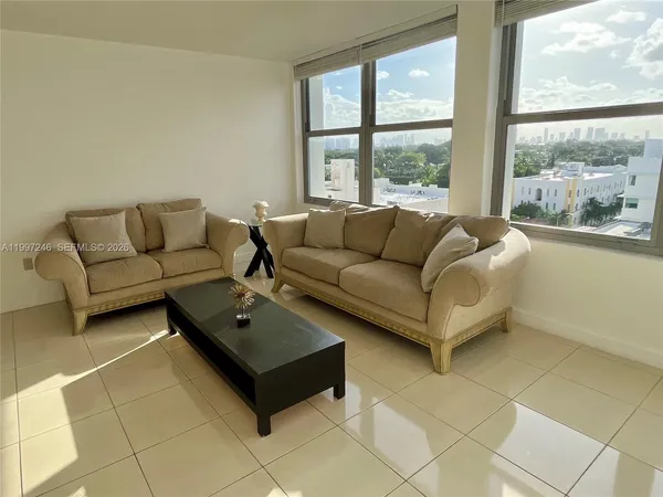 a living room with furniture and a large window