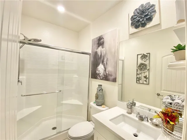 a bathroom with a sink mirror toilet and shower