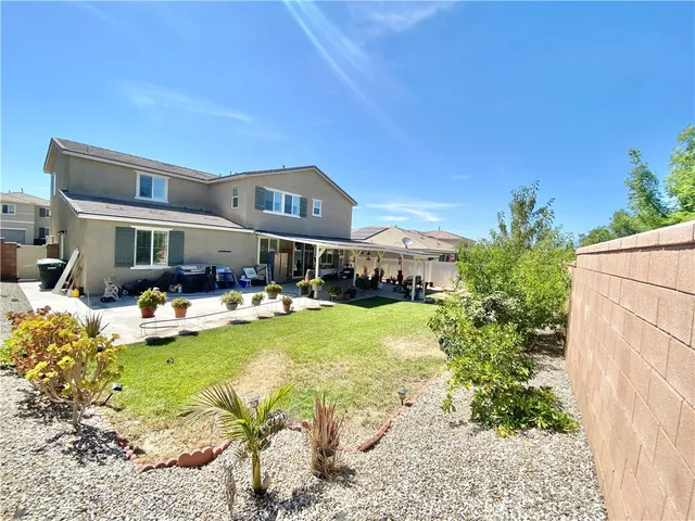 a view of an house with swimming pool garden and patio