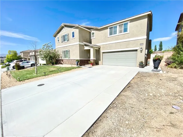 a view of a white building among the street and houses