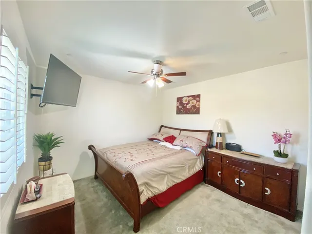 a bedroom with a bed and a potted plant