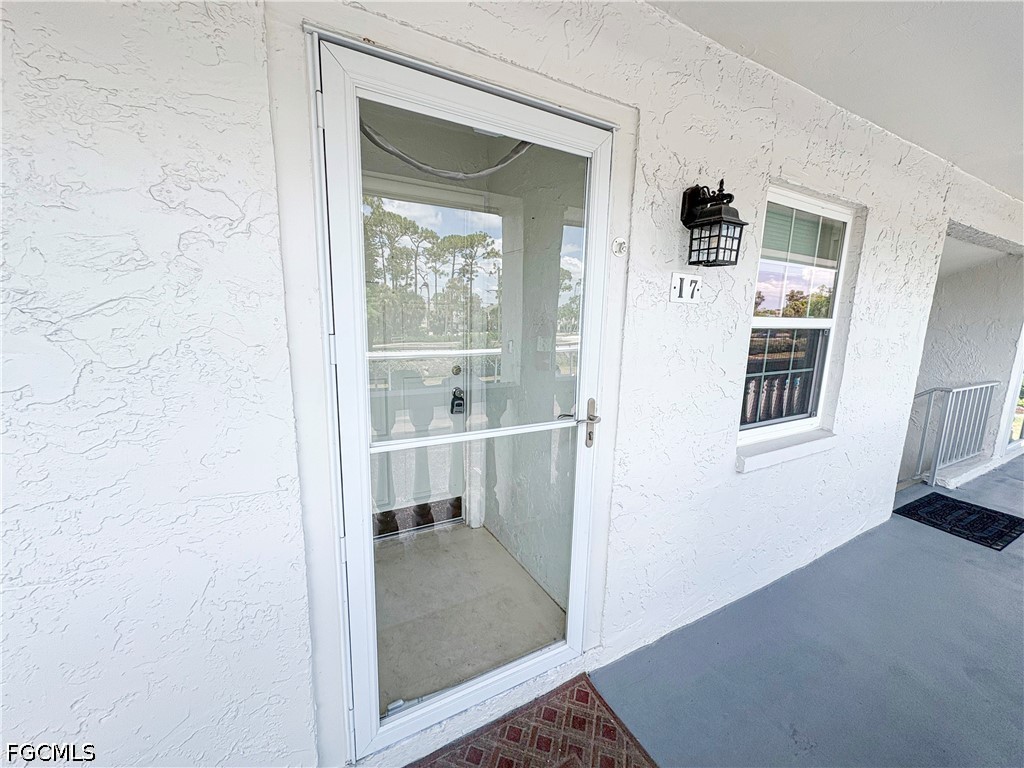 1830 Brantley Road, Unit I7 Fort Myers, FL 33907 - Photo 3 of 34 hallway with wooden floor and windows