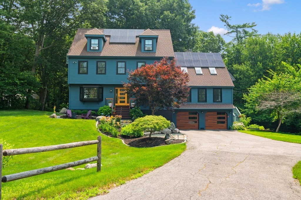 17 Woodman Road Amesbury, MA 01913 - Photo 1 of 38 a front view of a house with a yard and potted plants