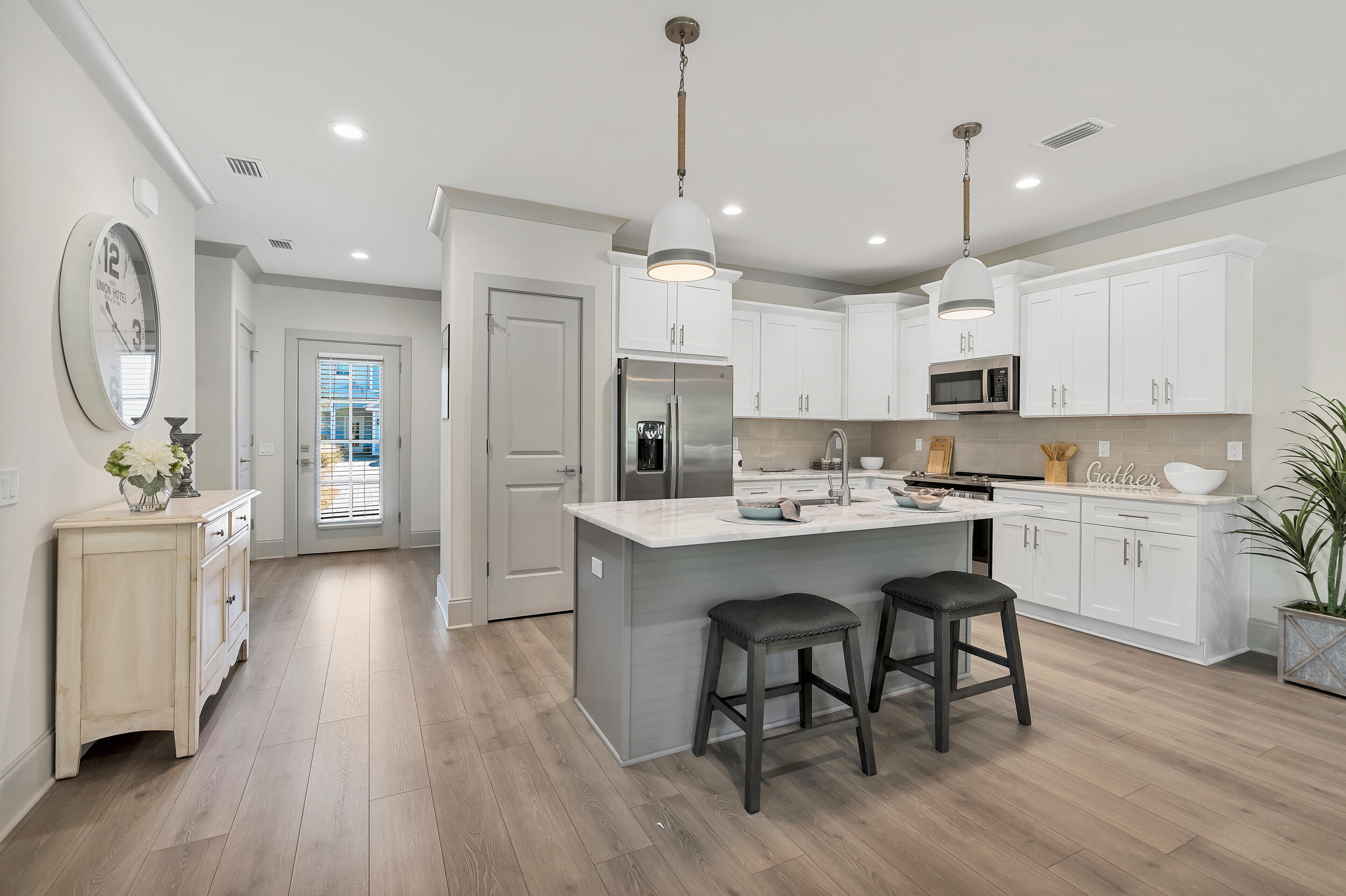16 Golden Bell Ct Inlet Beach, Unit 16C Inlet Beach, FL 32461 - Photo 13 of 32 a large kitchen with cabinets chairs and wooden floor