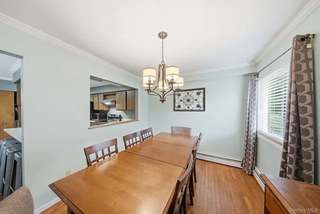 a view of a room with furniture and wooden floor