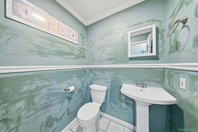 a bathroom with a sink mirror and toilet