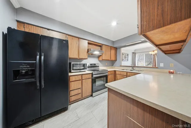 a kitchen with a refrigerator and a sink