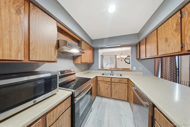 a kitchen with a sink stove and cabinets