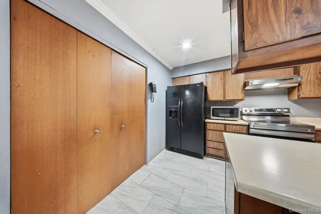 a kitchen with stainless steel appliances granite countertop a refrigerator and a stove