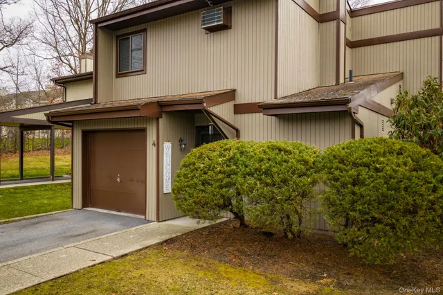 a view of a house with wooden fence