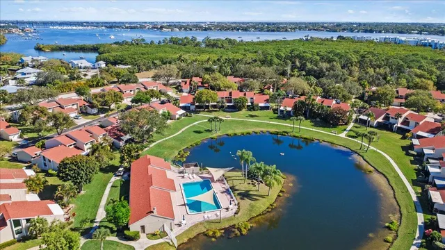 an aerial view of a house with a garden and lake view