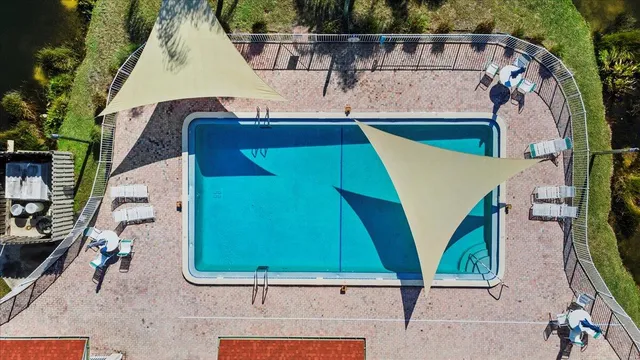 swimming pool view with a outdoor seating