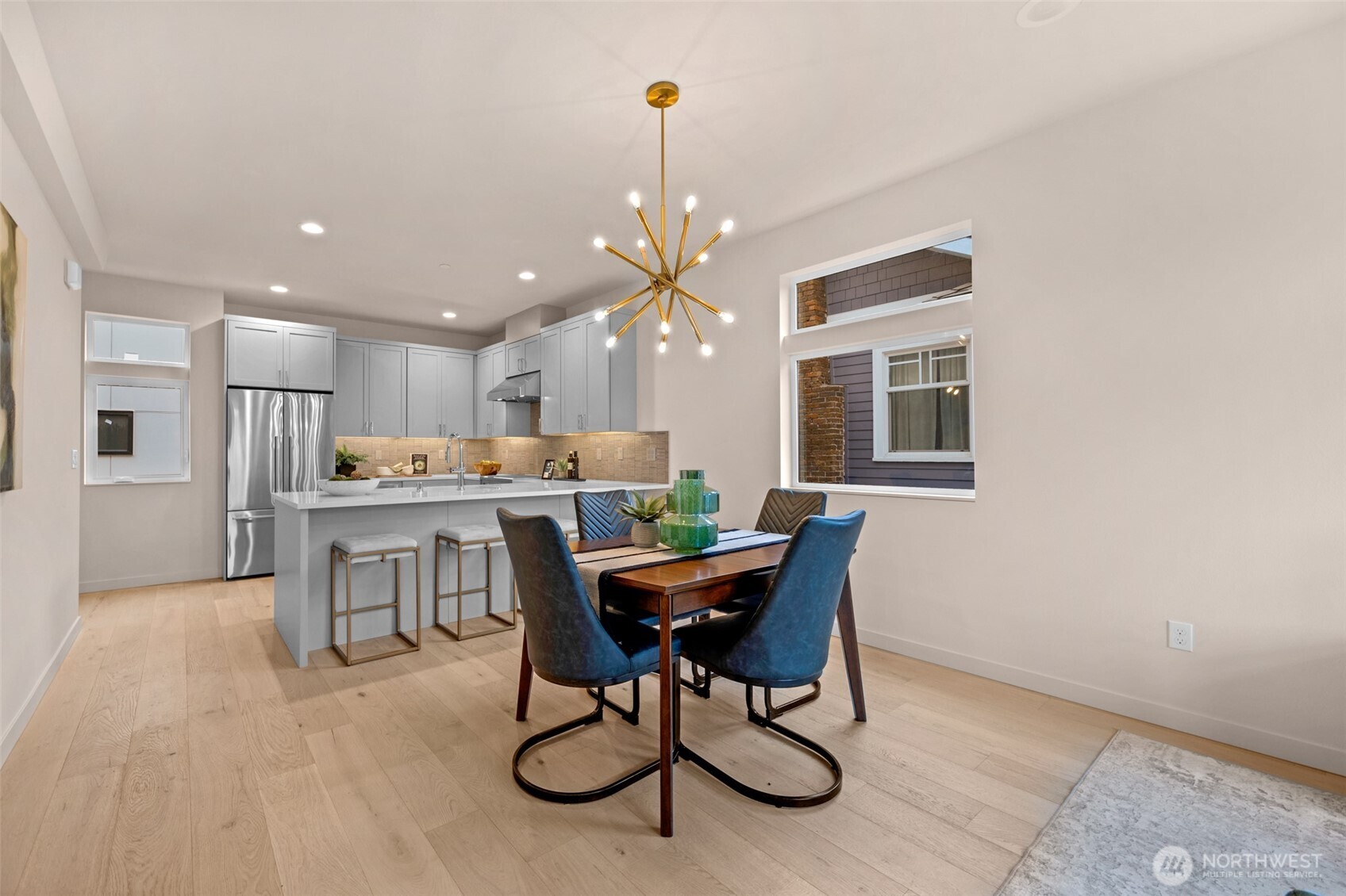 1416 North 47th Street, Unit B Seattle, WA 98103 - Photo 13 of 33 a kitchen with a dining table chairs and refrigerator