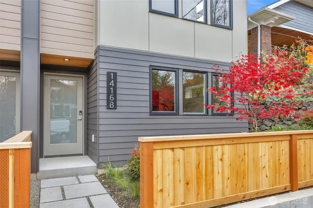 a view of a brick house with potted plants